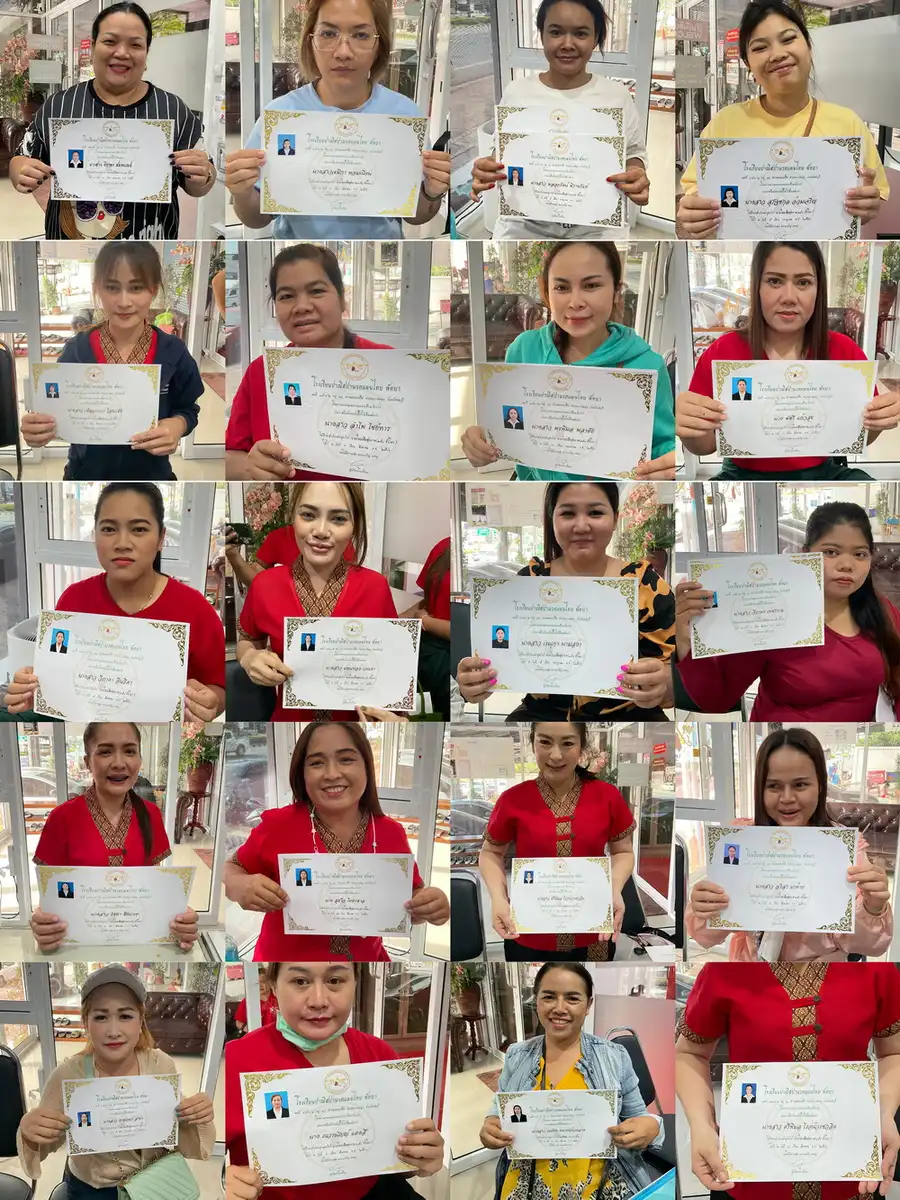 Dozens of Michael Thai Massage School graduates holding their certificates